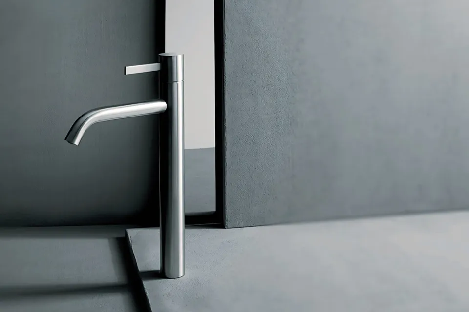 tall single-lever basin mixer with an angled spout in brushed steel