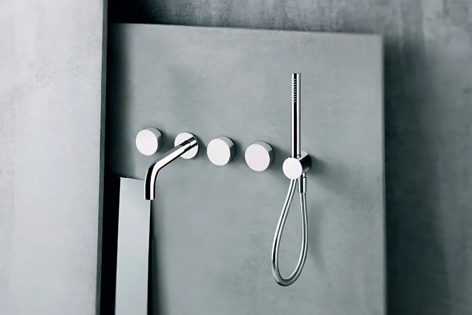 wall-mounted shower set with four round controls and a handshower