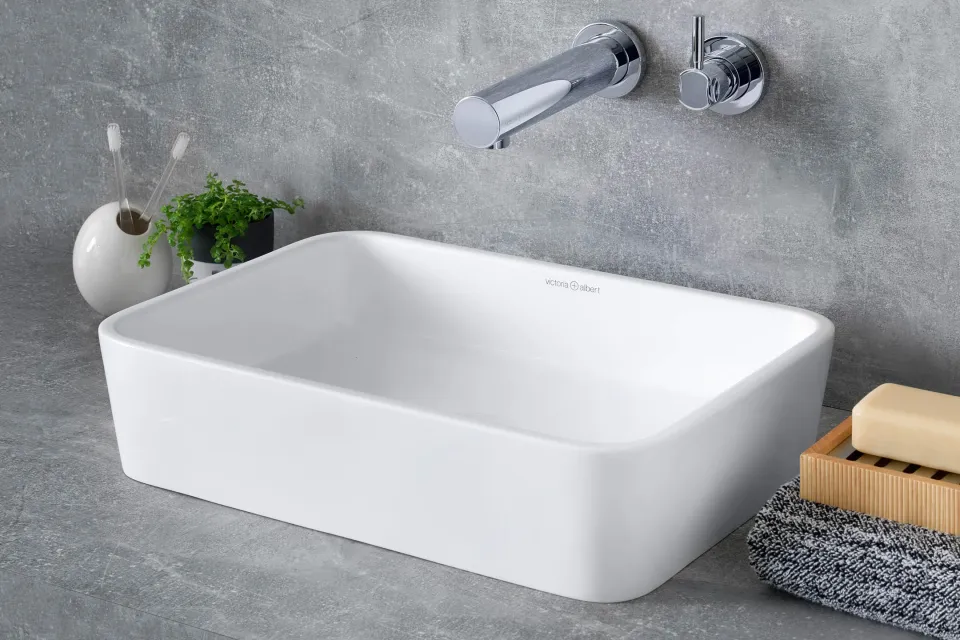 white rectangular countertop basin with a wall-mounted mixer