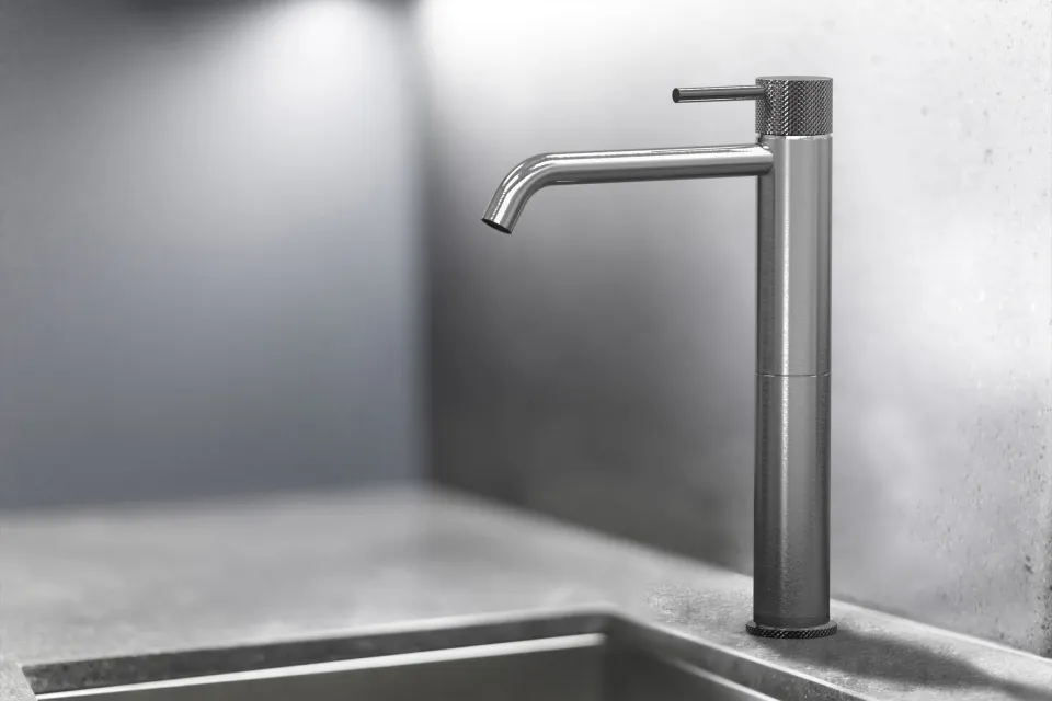 tall dark single-lever basin mixer over a kitchen sink